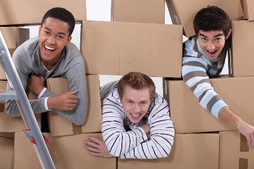 Professional movers handling packed boxes and furniture in Bromley