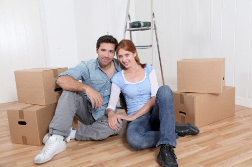 Professional removals team packing fragile household items